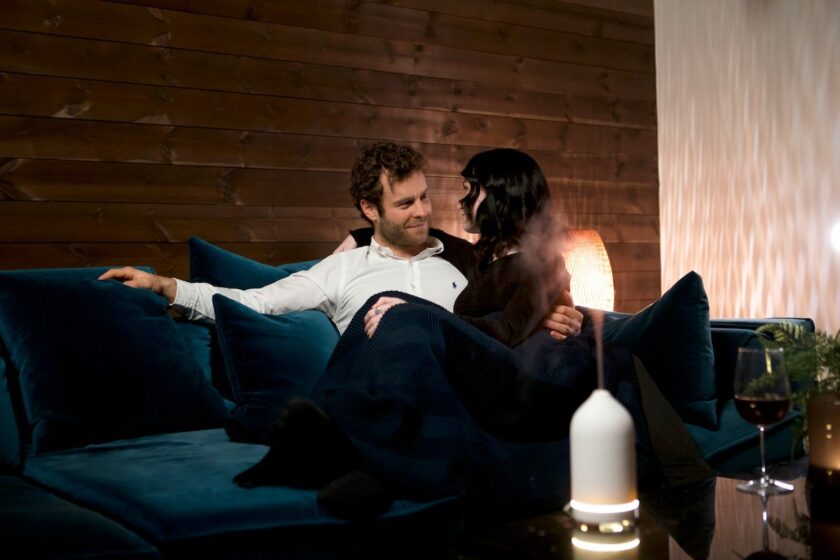 Coppia abbracciata in un’atmosfera sensuale e calda, con luce soffusa